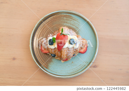Fresh Strawberry and Blueberry Cream Croissant on a Rustic Ceramic Plate Fresh Strawberry and Blueberry Cream Croissant on a Rustic Ceramic Plate 122445982
