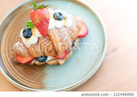Fresh Strawberry and Blueberry Cream Croissant on a Rustic Ceramic Plate Fresh Strawberry and Blueberry Cream Croissant on a Rustic Ceramic Plate 122446000