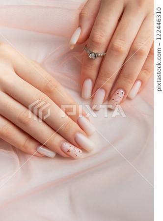 Female hands with fashionable ombre manicure on pink background Female hands with fashionable ombre manicure on pink background 122446310
