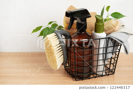 Eco friendly cleaning products inside metal basket on wooden table 122446317
