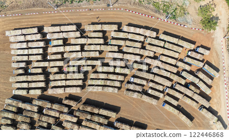 Drone shot aerial view of high angle view of a lot of sugarcane trucks queuing up 122446868