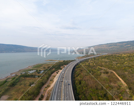 The M6  motorway Expressway Nakhon Ratchasima Province - Bang Pa-in. Lam Ta Khong River and Mountain. Drone shot of scenic landscape rural place traffic. Nakhon Ratchasima Thailand. Motorway Korat 122446911