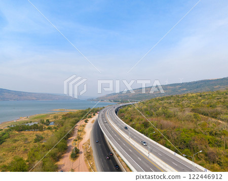 The M6  motorway Expressway Nakhon Ratchasima Province - Bang Pa-in. Lam Ta Khong River and Mountain. Drone shot of scenic landscape rural place traffic. Nakhon Ratchasima Thailand. Motorway Korat 122446912