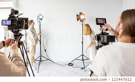 Studio lighting technician. Photograph lamp. Media team prepares filming equipment for work. Professional technology video recording. Studio lighting technician. Photograph lamp. Media team prepares filming equipment for work. Professional technology video recording. 122447012