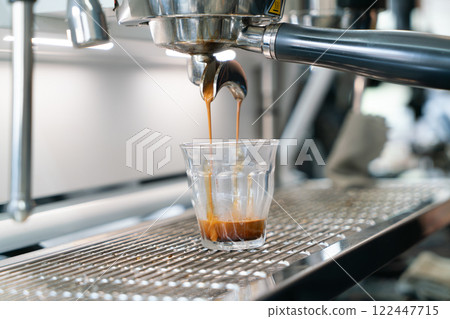 Fresh Espresso Shot Pouring from Coffee Machine in Cafe Fresh Espresso Shot Pouring from Coffee Machine in Cafe 122447715