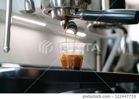 Fresh Espresso Shot Pouring from Coffee Machine in Cafe 122447719