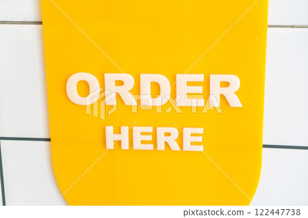 Order Here Sign on Bright Yellow Background for Cafe and Restaurant 122447738