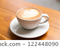 Hot Cappuccino with Latte Art on Wooden Table 122448090