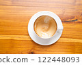 Hot Cappuccino with Latte Art on Wooden Table 122448093