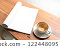 Open Blank Book and Cappuccino on Wooden Table in Cozy Cafe 122448095
