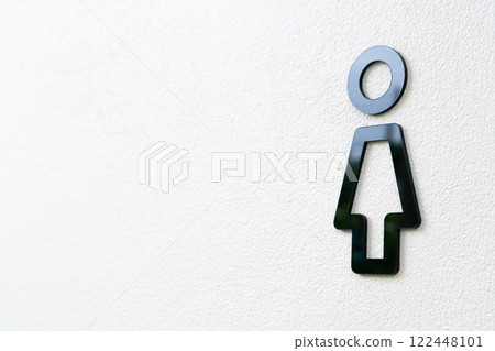 Minimalist Female Restroom Sign on a White Wall 122448101