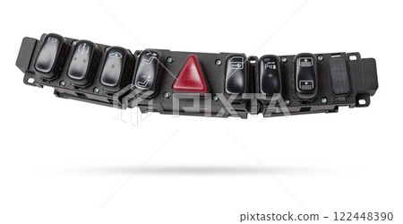 Black plastic block of car control panel with red emergency stop button for signal lights, spare part on a white isolated background in a photo studio for sale and installation in a auto service. Black plastic block of car control panel with red emergency stop button for signal lights, spare part on a white isolated background in a photo studio for sale and installation in a auto service. 122448390