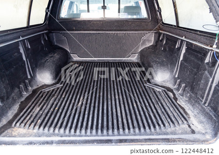 The body space of the trunk of a car in the back of a pickup truck for transporting goods like on a truck. 122448412