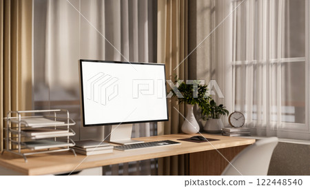 A computer and decorative items on a wooden desk by the window in a cozy contemporary room. 122448540