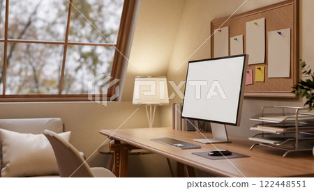 A close-up of a computer and decorative items on a hardwood desk in a warm, cozy room. A close-up of a computer and decorative items on a hardwood desk in a warm, cozy room. 122448551