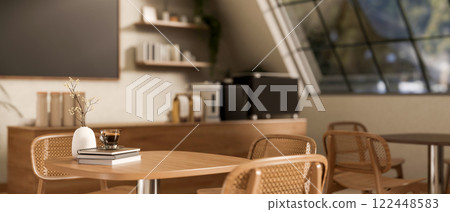 A close-up of a wooden table and armchairs in a cozy contemporary coffee shop. 122448583