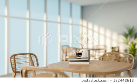 A close-up of a minimalist hardwood table and chairs in a simple white restaurant or a coffee shop. A close-up of a minimalist hardwood table and chairs in a simple white restaurant or a coffee shop. 122448618