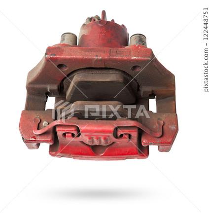 Old red metal brake caliper on a white background for replacement during the repair of the chassis or for a catalog of spare parts for sale on auto parsing. 122448751