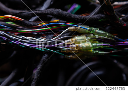 A cable of matted wires of different colors with connectors in the electrical wiring of the car. Internet line in the work of the provider. A cable of matted wires of different colors with connectors in the electrical wiring of the car. Internet line in the work of the provider. 122448763