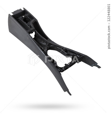 Dismantled car center console on a white isolated background in a photo studio - gray plastic panel with metal elements, spare part for sale and installation in a auto service center. 122448801