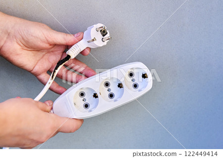 Extension cord overload, charred electrical cord with tee. 122449414