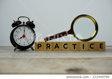 Time to Practice with wooden blocks alphabet letters and Magnifying glass on wooden background 122449790