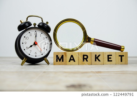 Time to Market with wooden blocks alphabet letters and Magnifying glass on wooden background 122449791