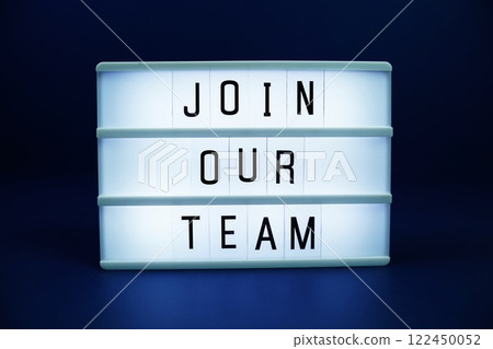 Join Our Team letterboard text on LED Lightbox on blue background 122450052