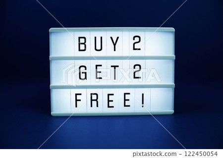 Buy 2 Get 2 Free! letterboard text on LED Lightbox on blue background 122450054
