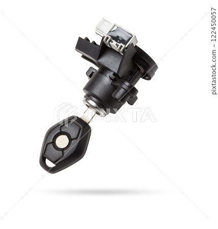 Detail of a car spare part made of black plastic and metal - keyhole lock with key for opening the trunk separately, isolated on a white background. Repair in a car workshop, equipment for sale. 122450057
