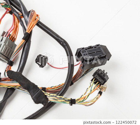 A cable of matted wires of different colors with connectors in the electrical wiring of the car. Internet line in the work of the provider. A cable of matted wires of different colors with connectors in the electrical wiring of the car. Internet line in the work of the provider. 122450072