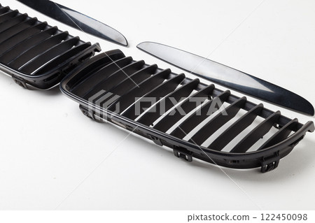 radiator grille on a white background made of shiny chromed metal is an element of the car body that protects and passes air to the engine. Design element and tuning replacement in the workshop. radiator grille on a white background made of shiny chromed metal is an element of the car body that protects and passes air to the engine. Design element and tuning replacement in the workshop. 122450098