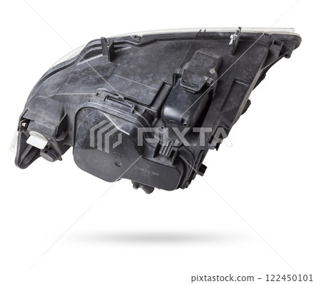 Stylish xenon headlight of a German car - optical equipment with a lamp inside on a white isolated background. Spare part for auto repair in a car workshop. 122450101