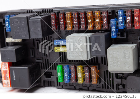 Pavlodar, Kazakhstan - 04.20.2020: Automotive fuses and relay box with mercedes-Benz and Hella Logo . Catalog of spare parts. Pavlodar, Kazakhstan - 04.20.2020: Automotive fuses and relay box with mercedes-Benz and Hella Logo . Catalog of spare parts. 122450133