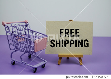 Free Shipping text message and trolley shopping cart on purple background 122450976