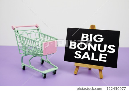 Big Bonus Sale text message and trolley shopping cart on purple background Big Bonus Sale text message and trolley shopping cart on purple background 122450977