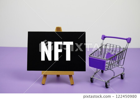 NFT text message and trolley shopping cart on purple background 122450980