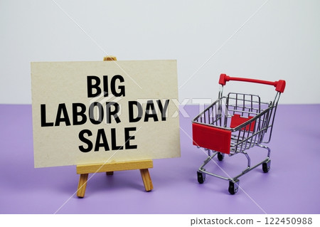 Big Labor day sale text message and trolley shopping cart on purple background Big Labor day sale text message and trolley shopping cart on purple background 122450988