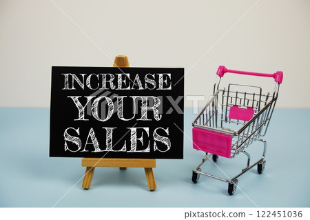 Increase Your Sales text message and trolley shopping cart on blue background 122451036