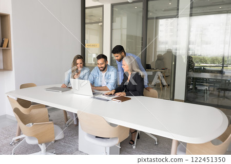 Four young and mature workmates collaborating on joint online project 122451350