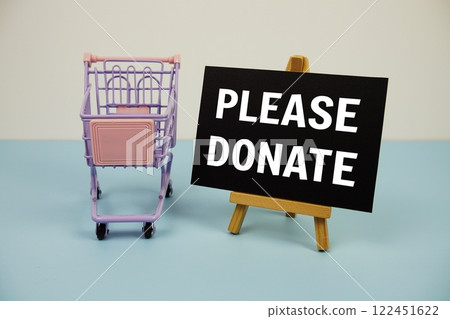 Please Donate text message and trolley shopping cart on blue background Please Donate text message and trolley shopping cart on blue background 122451622