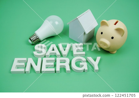 Save Energy alphabet letters with house model, piggy bank and LED light bulbs on green background, Saving and Eco friendly concept 122451705