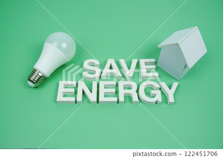 Save Energy alphabet letters with house model and LED light bulbs on green background, Saving and Eco friendly concept 122451706