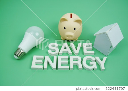 Save Energy alphabet letters with house model, piggy bank and LED light bulbs on green background, Saving and Eco friendly concept Save Energy alphabet letters with house model, piggy bank and LED light bulbs on green background, Saving and Eco friendly concept 122451707