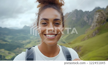 Traveler woman with backpack hiking on top of rocky peak. Snowy mountain landscape. Climber girl on summit. Active lifestyle, climbing, extreme sport concept. Background travel tourism vacations  122451845