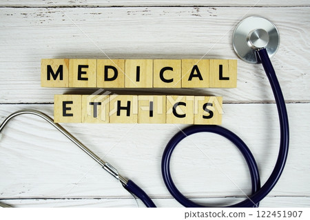 Medical Ethics with wooden blocks alphabet letters and stethoscope on wooden background, Healthy and wellness concept 122451907