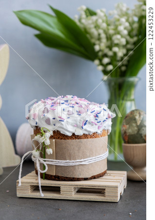 Sweet homemade Easter cake panettone with meringue and creative decoration food. Preparation for Christian holiday Kulich. Easter eggs and bunny 122453229