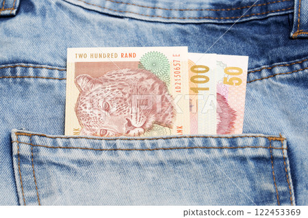 Old South African Rand in the pocket of blue jeans Old South African Rand in the pocket of blue jeans 122453369