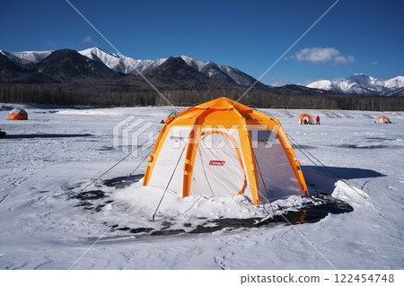 A view of the snowy mountains from a smelt fishing tent on the completely frozen Lake Nukabira 122454748