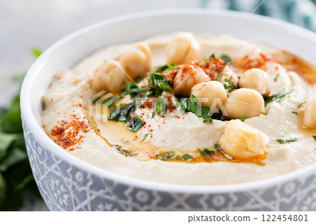 Chickpea hummus with olive oil, parsley and paprika. Close up Chickpea hummus with olive oil, parsley and paprika. Close up 122454801